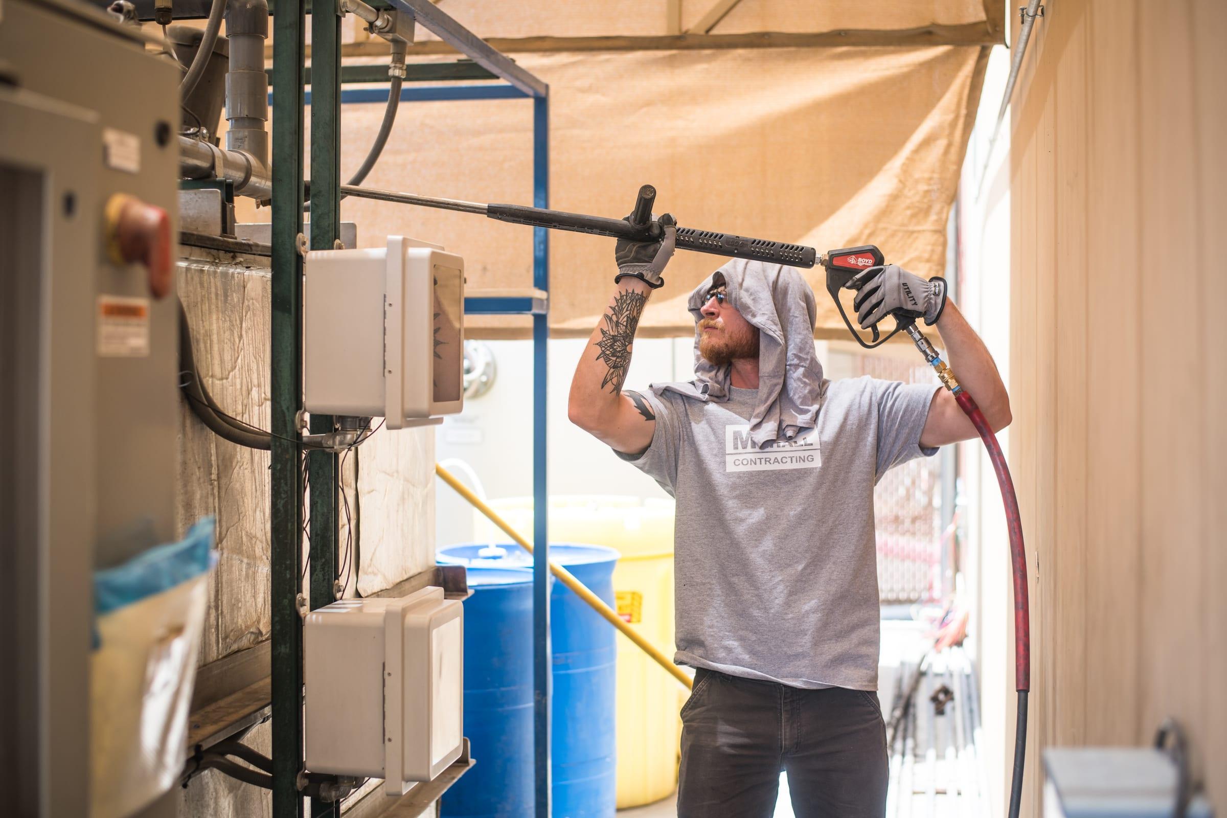 Mehall technician jetting a treatment system inside a plant