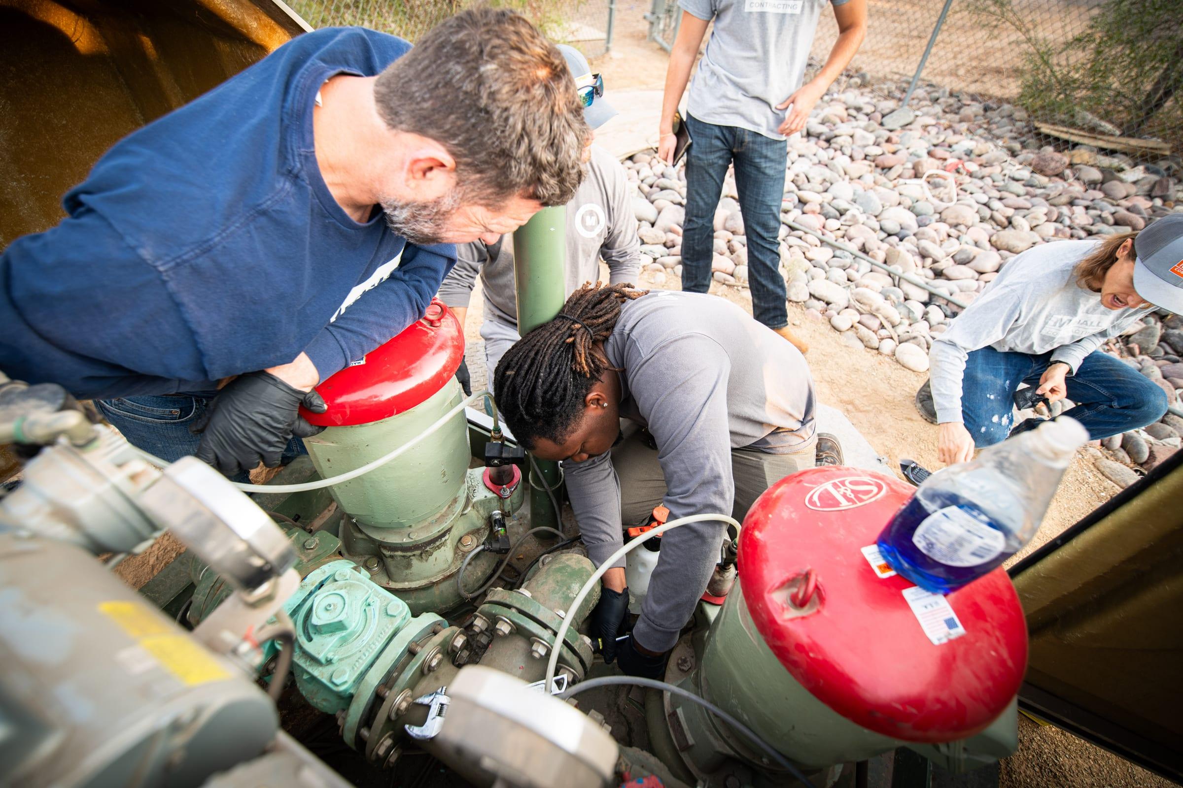 Crew checking a lift station pump package