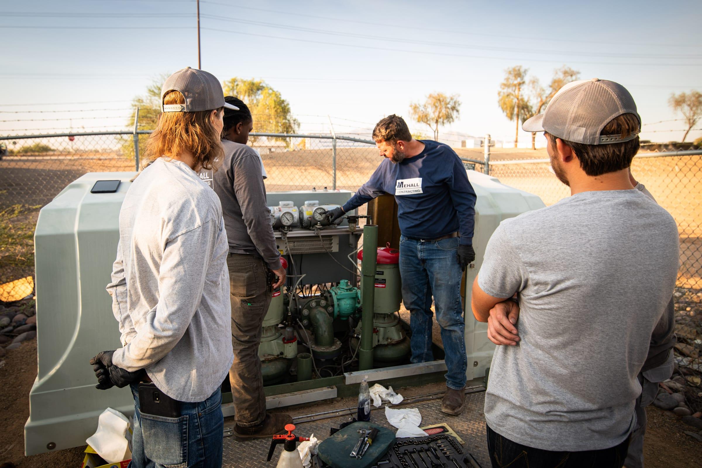 Crew servicing a lift station pump package