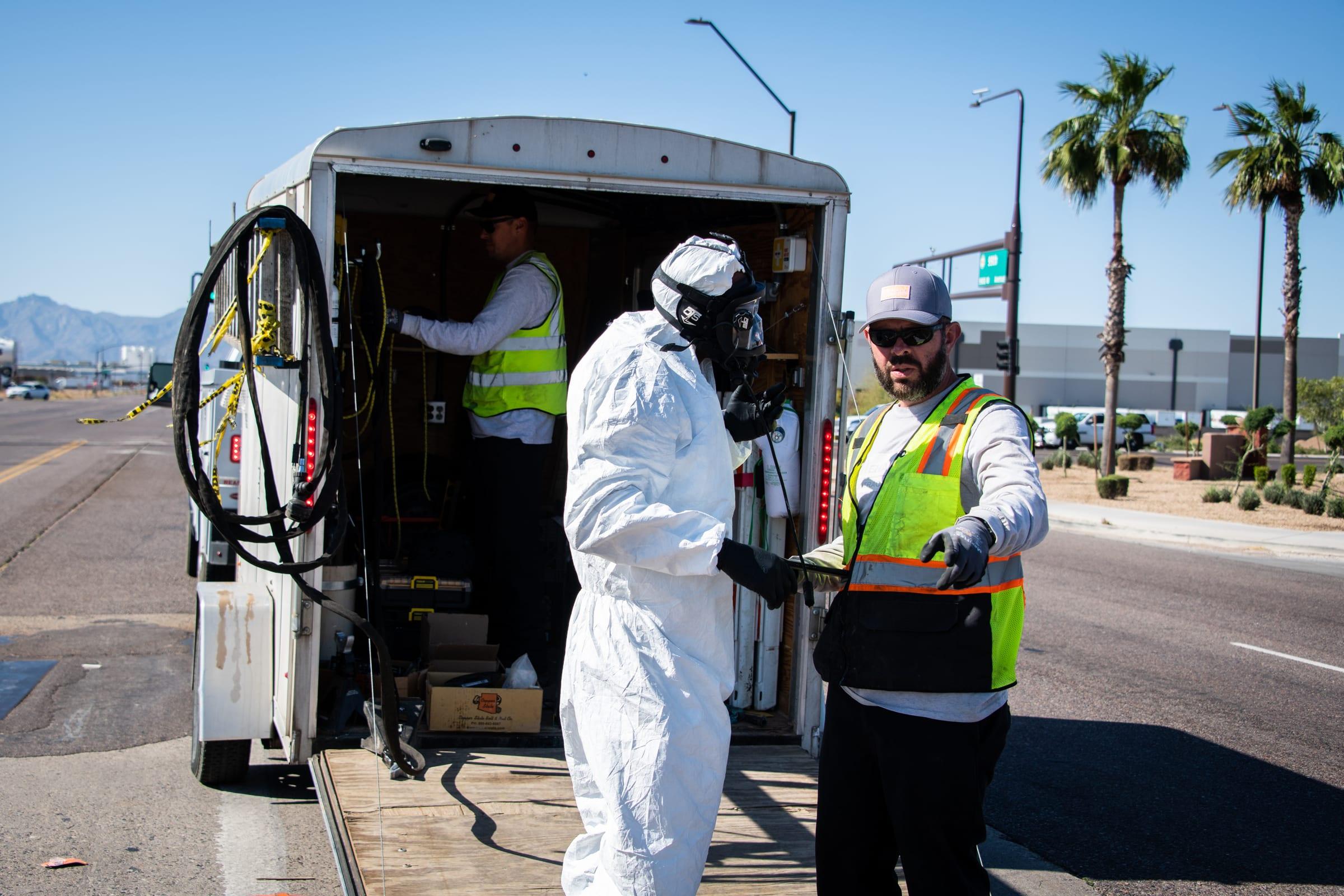 Technician suiting up at the confined space trailer